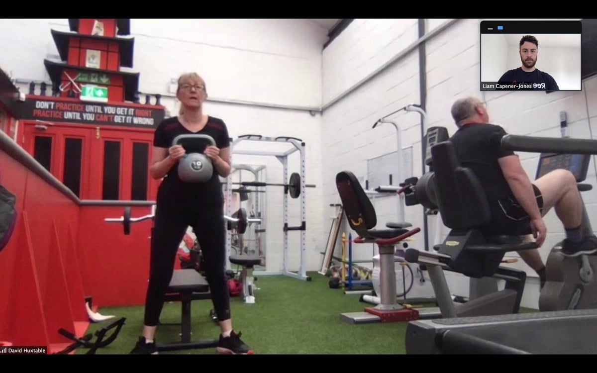 Squat with kettle bell in Gorseinon working with personal trainer online