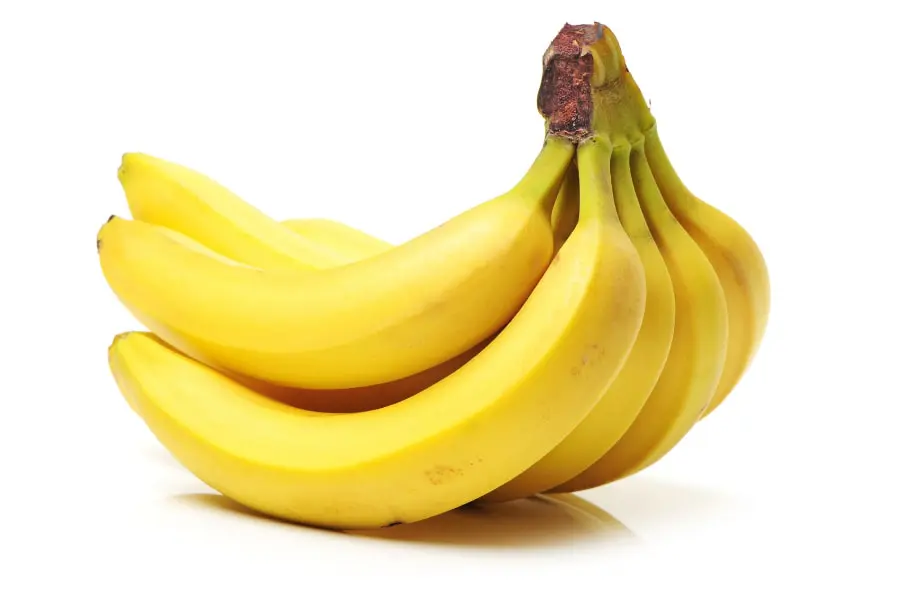 Mood Boosting foods A bunch of ripe yellow bananas on a white background